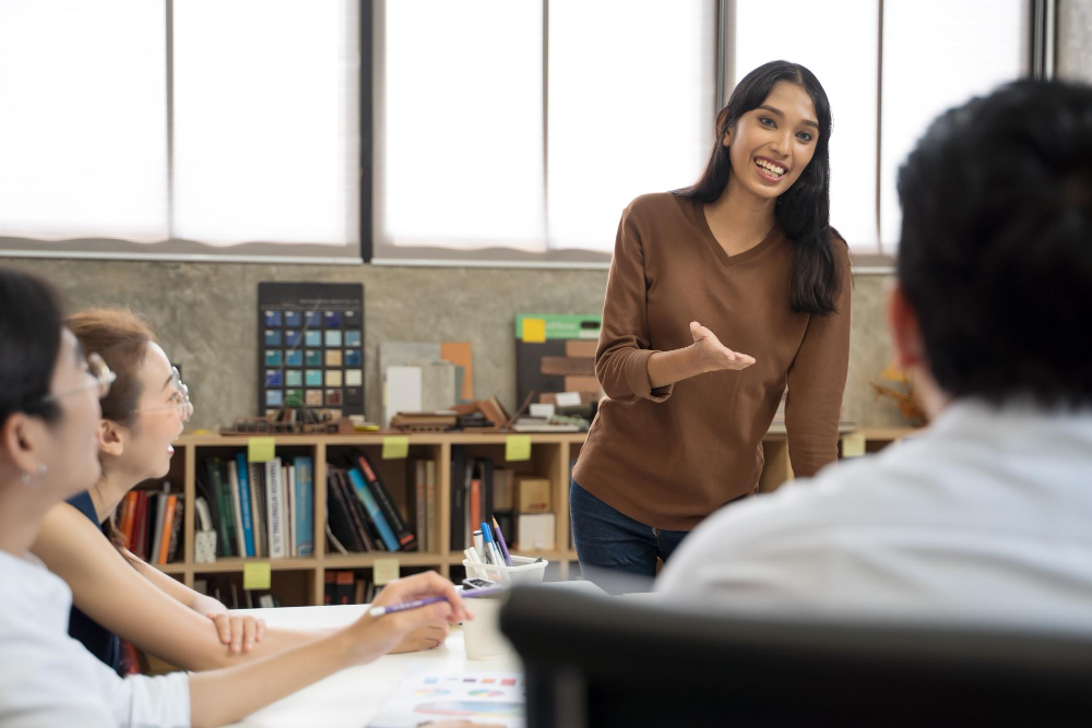 Female teacher speaking to students in a classroom