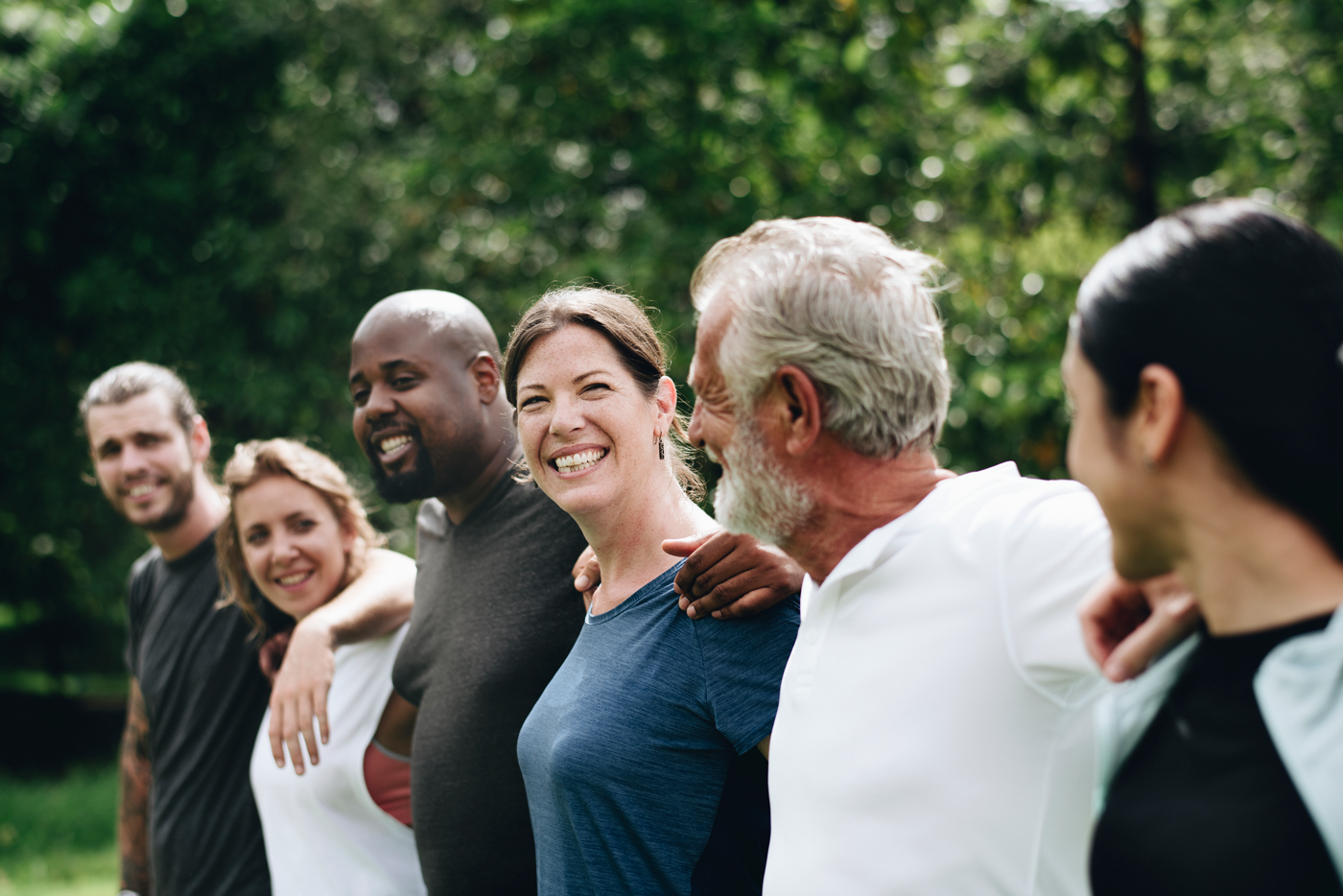 Diverse group of smiling people standing together outdoors